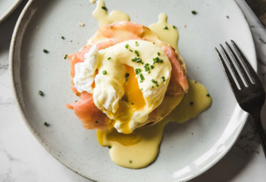 Keto eggs Benedict on plate with fork and knife