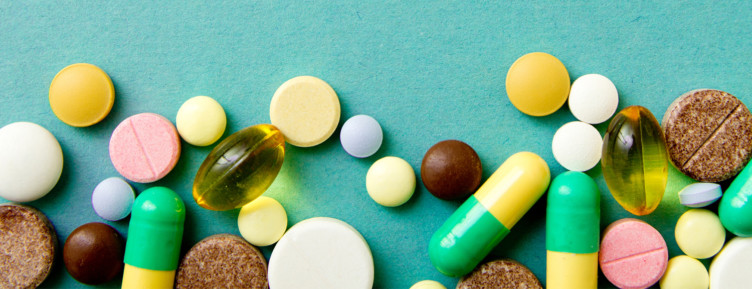 Array of vitamins and pills on blue background
