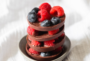 Plate with dark chocolate and mixed berry clusters