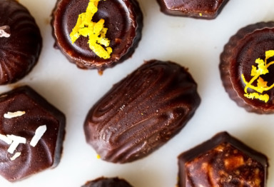 Variety of low-carb chocolate candies with decorative zest and coconut flakes