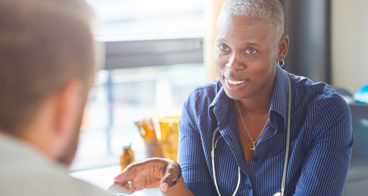 man talking to doctor about side effects