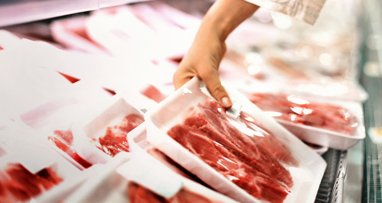 Person buying red meat at store