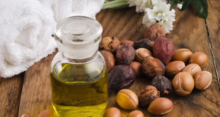 bottle of argan oil and argan fruit