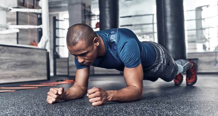 Man doing plank on gym floor