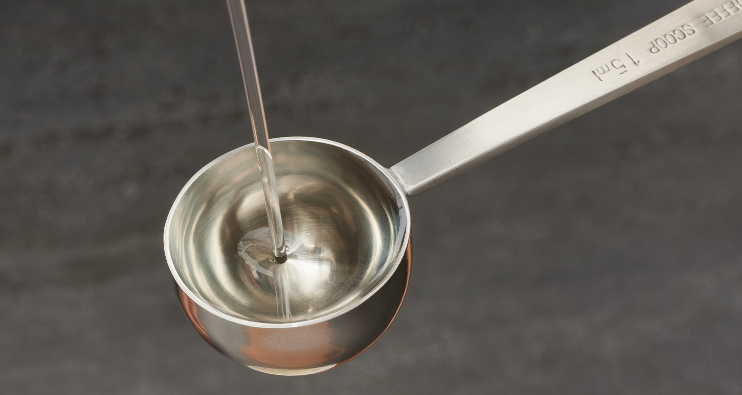 mct oil pouring into scoop