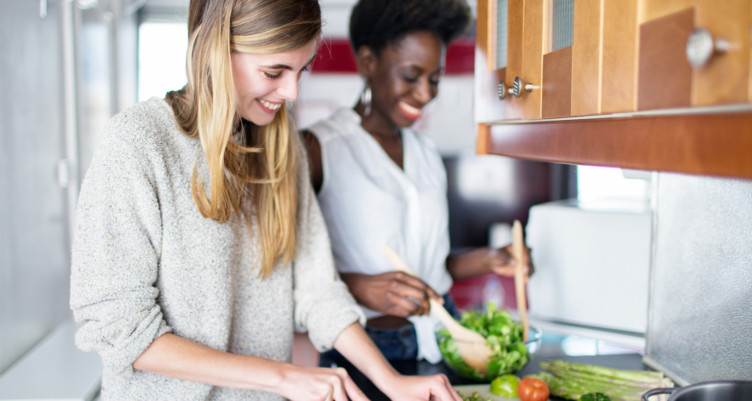 Two women preparing meal together