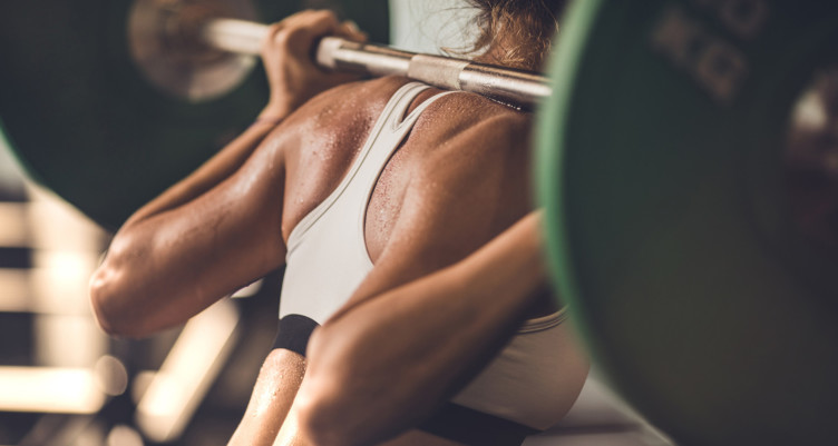 woman squatting with barbell