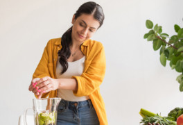 Healthy woman using blender