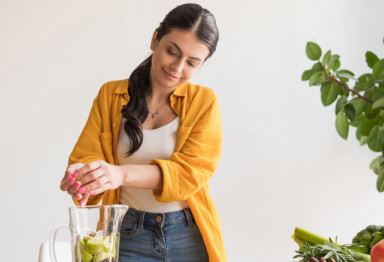 Healthy woman using blender