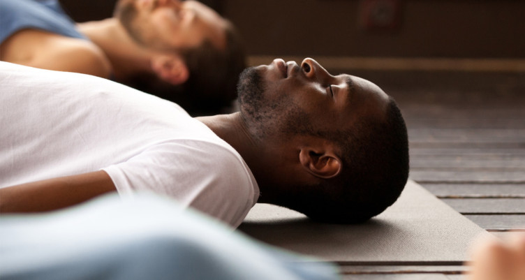 Man meditating on yoga mat