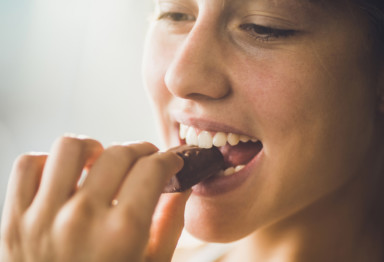 Woman eating chocolate for gut health