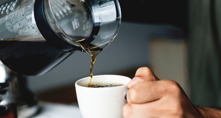 Pouring a cup of small batch single-origin coffee