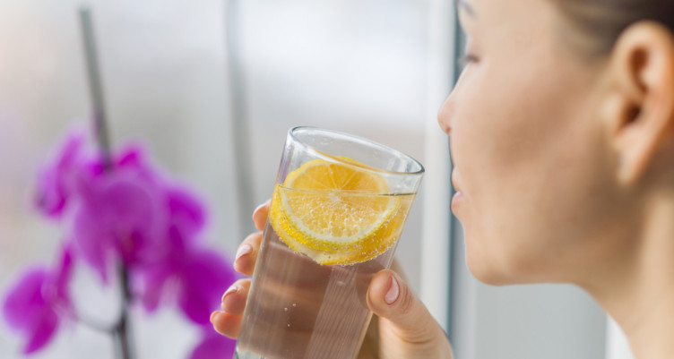 Woman sipping lemon water
