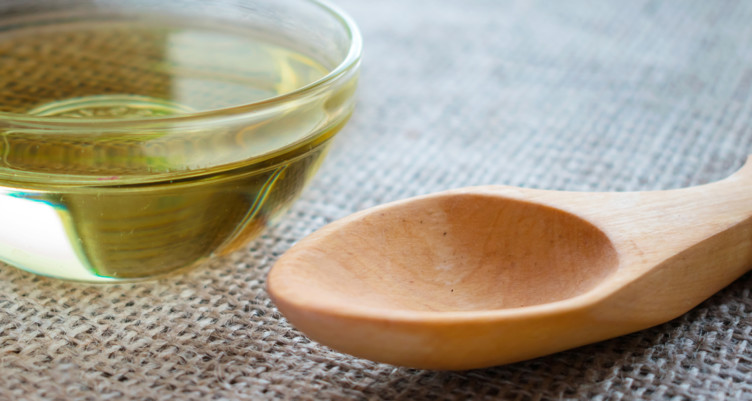 dish of mct oil sitting next to spoon