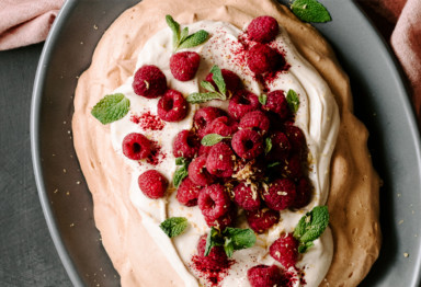 Keto pavlova on plate topped with berries