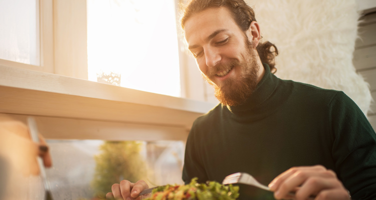 man preparing to eat a salad