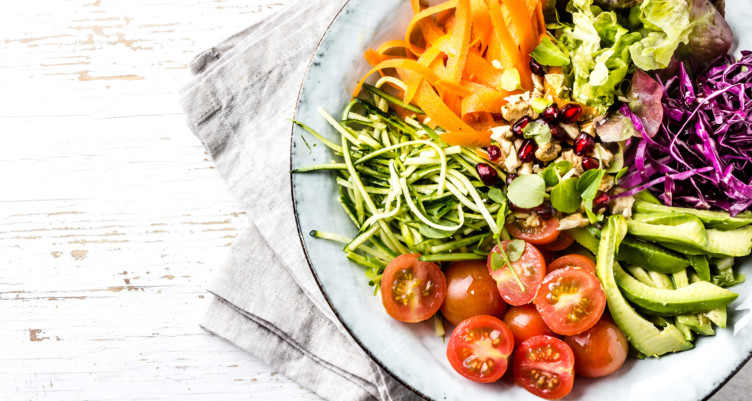 Bowl of vegetables on white dish towel