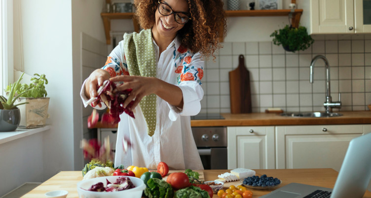 Woman preparing vegetables in kitchen