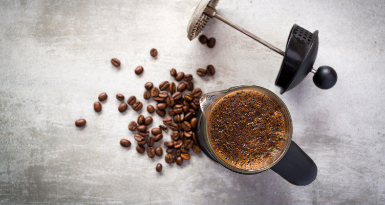 French press with coffee beans