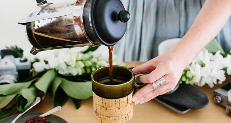 Woman pouring mug of coffee