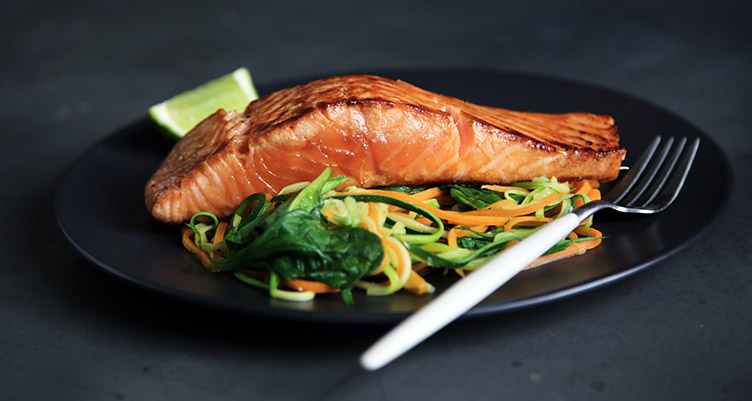 Salmon filet on plate of vegetables