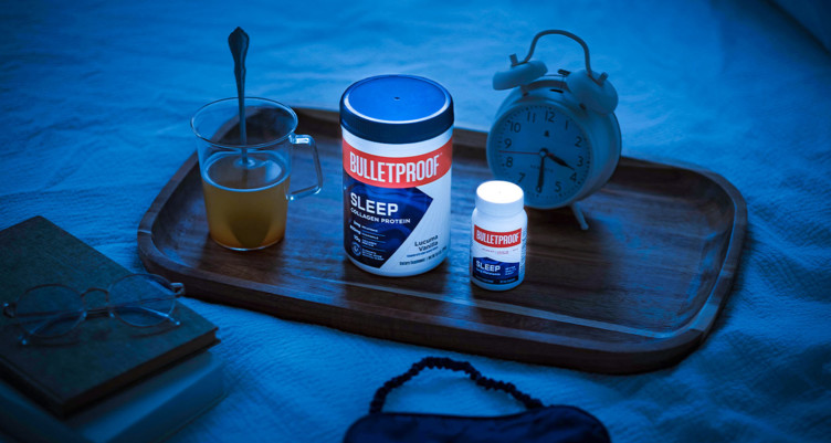 Bulletproof Sleep Collagen Protein and Bulletproof Sleep on a tray with tea and a clock.
