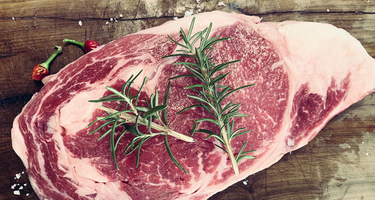 Raw steak with herbs