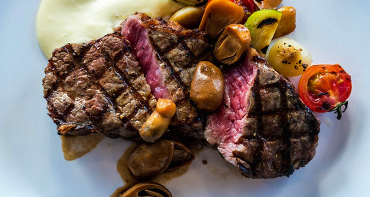 Grilled steak on white plate