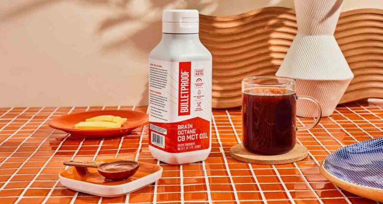 Bottle of Brain Octane Oil on counter with coffee & measuring spoon