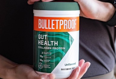 A man holding a tub of Bulletproof Unflavored Gut Health Collagen Protein