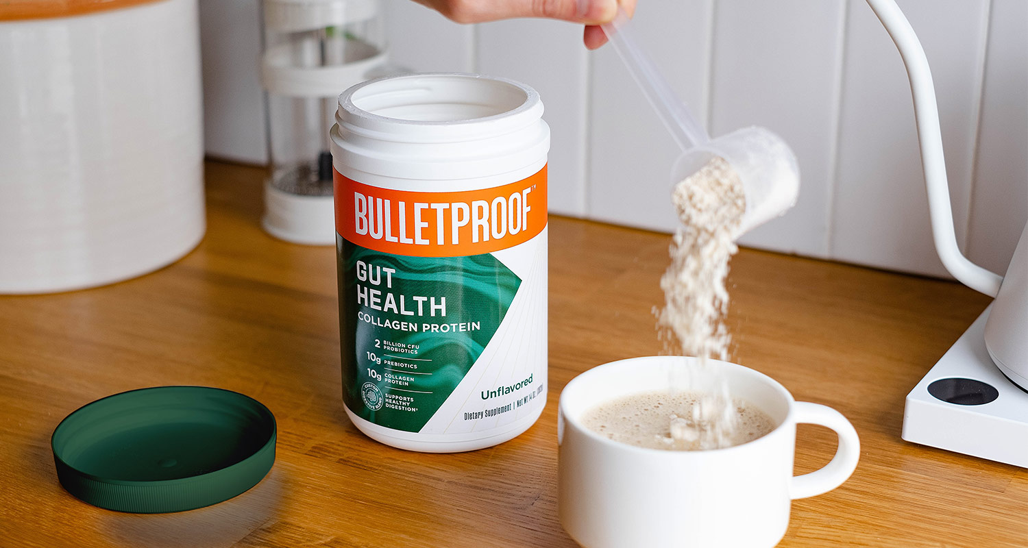 Adding a scoop of Bulletproof Gut Health Collagen Protein to a cup