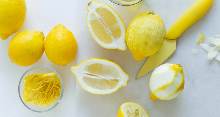 Sliced and whole lemons on white counter