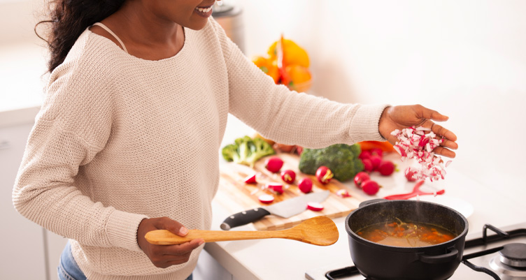 Woman cooking soup