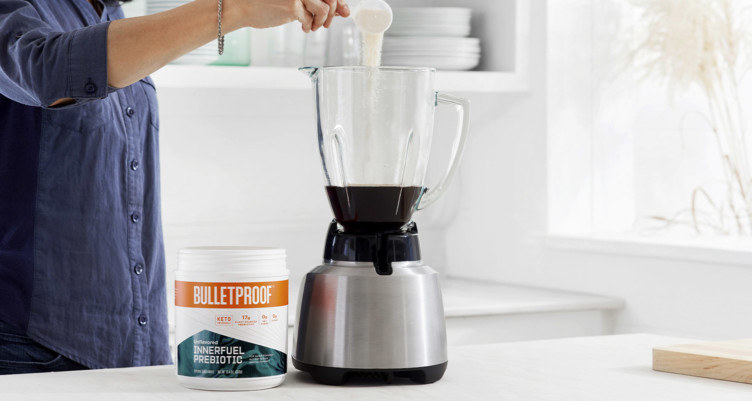 Adding Bulletproof InnerFuel Prebiotic to a blender of coffee