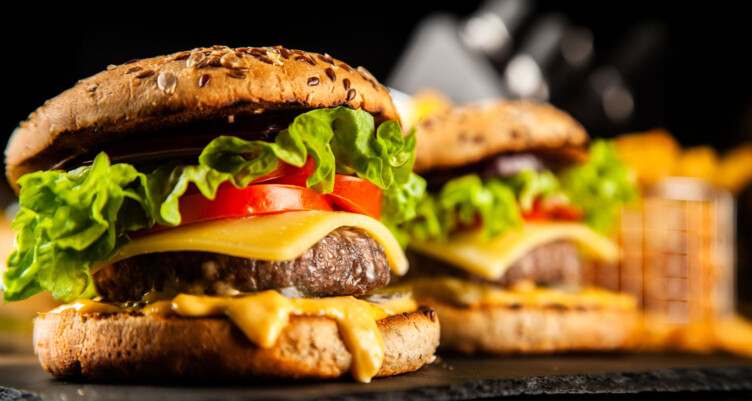 Close up of cheeseburgers sitting next to one another