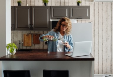 Woman pouring wine into bottle