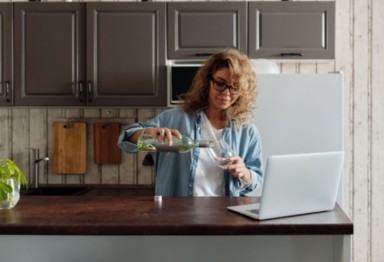 Woman pouring wine into bottle