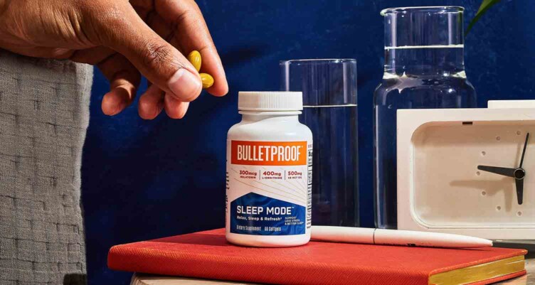 Sleep mode on nightstand with hand grabbing the supplements