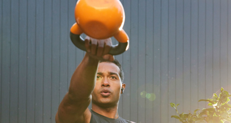 Man swinging kettlebell