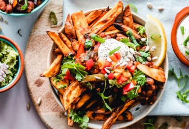 Sweet potato fries on bowl with toppings