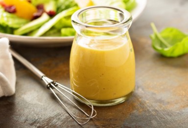 Keto honey mustard dressing in front of salad