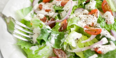 Salad drizzled with ranch dressing