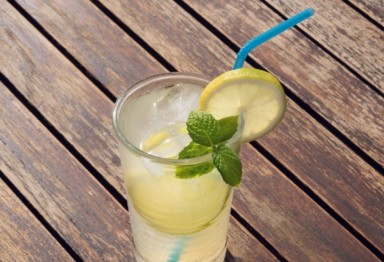 Glass of lemonade on wooden table