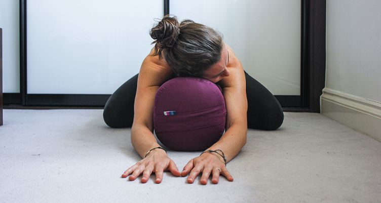 Woman with head on pillow and hands outstretched