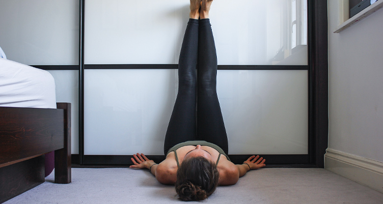 Woman with legs on wall