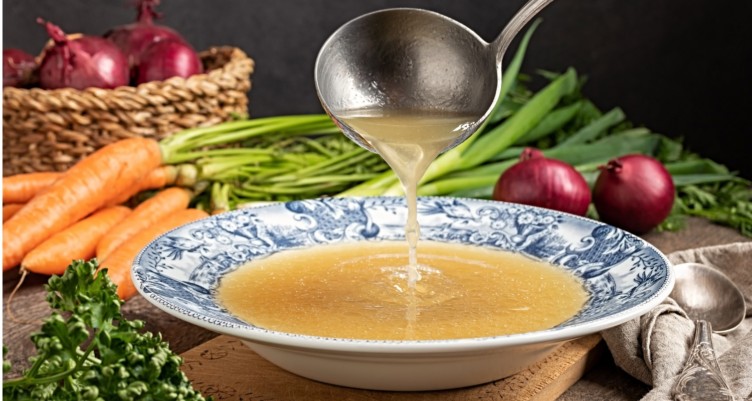 Ladling broth into a bowl