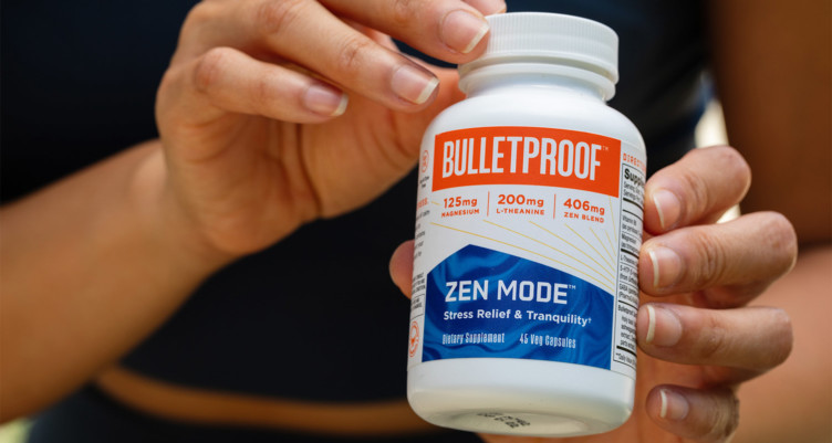 A hand holding a bottle of Bulletproof Zen Mode