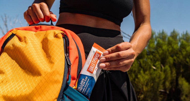 A Bulletproof Collagen Protein Bar in a backpack outdoors