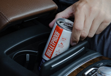 A can of Bulletproof Cold Brew Latte in a car console