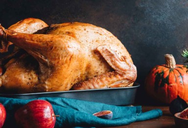 A Thanksgiving turkey accented with squash, figs and apples